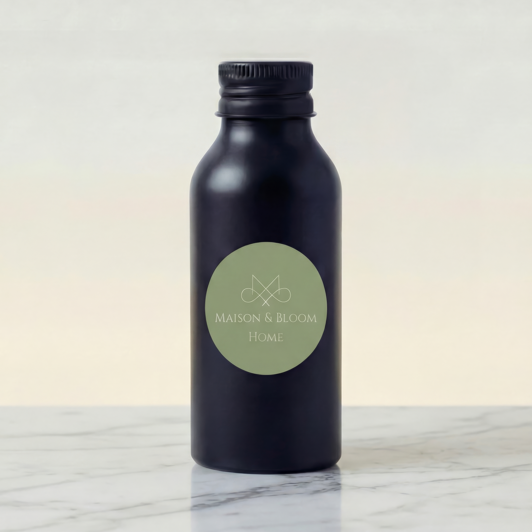 Matte black bottle with Maison & Bloom Home label on marble surface, minimalist design