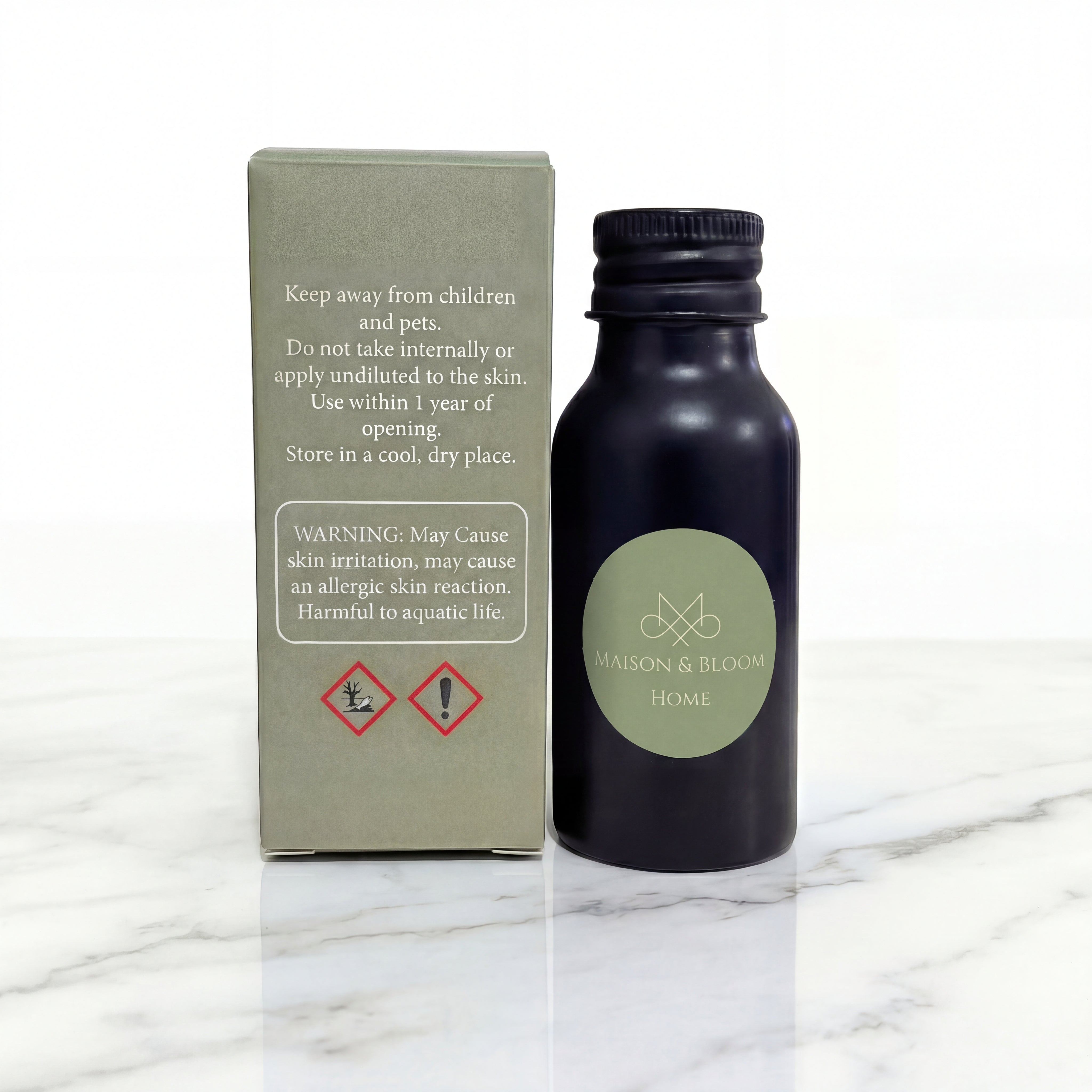 Aromatic oil bottle and box with safety warnings on marble surface