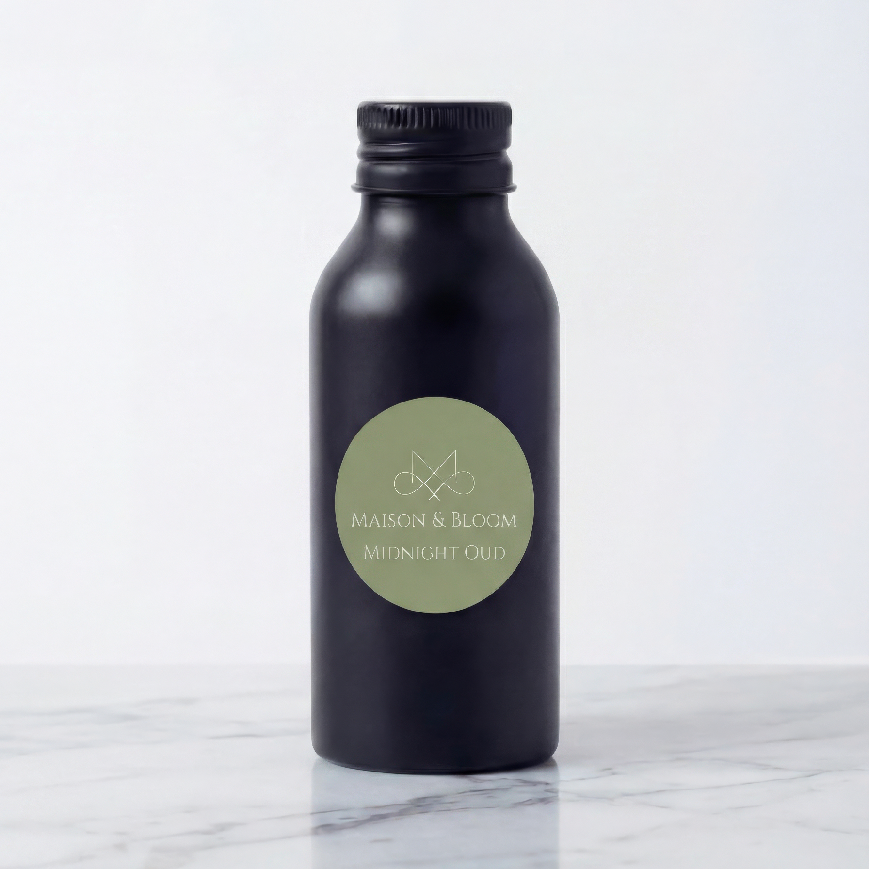 Matte black bottle labeled 'Midnight Oud' on marble surface, minimalist product shot