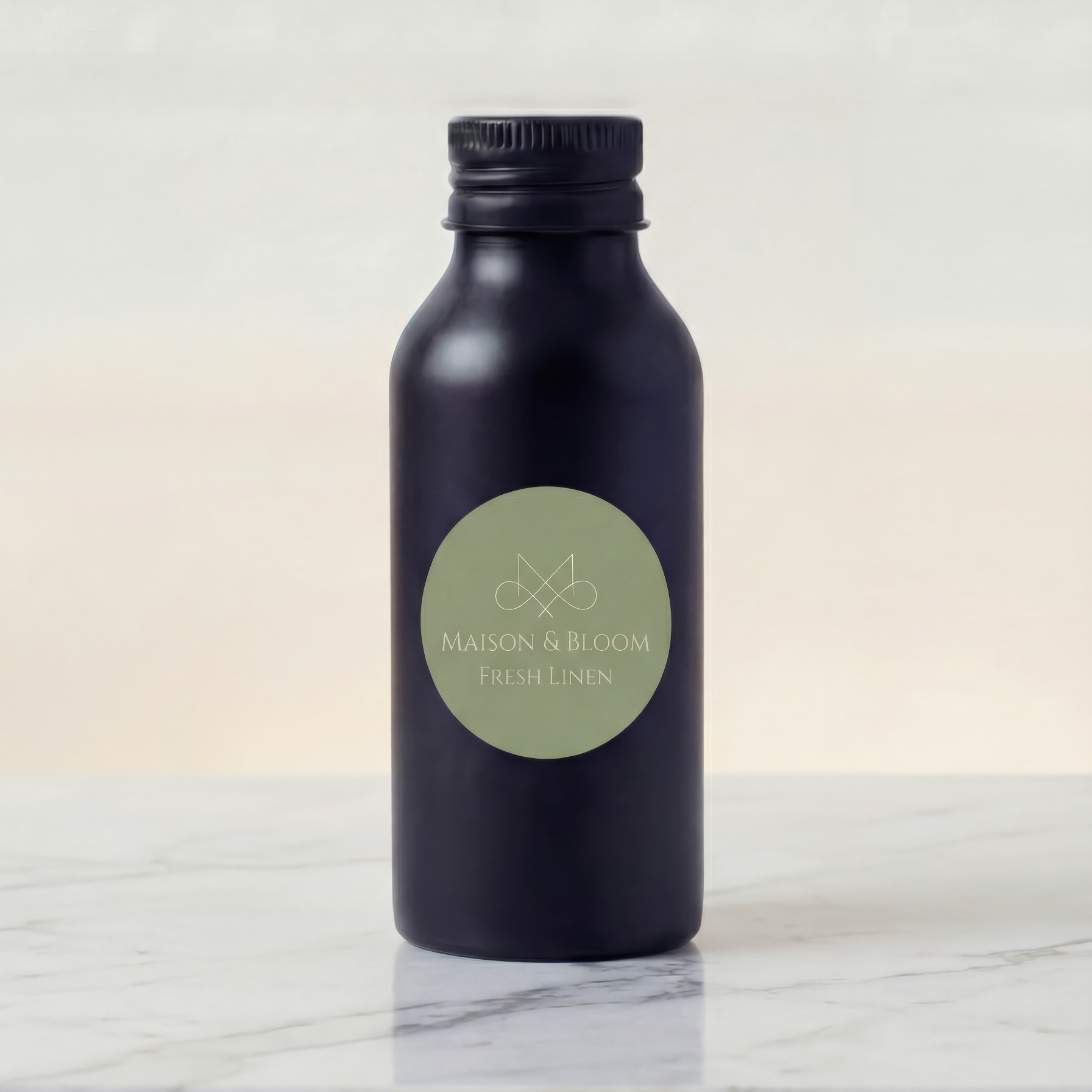 Matte dark bottle labeled Fresh Linen sitting on a marble surface, minimal design