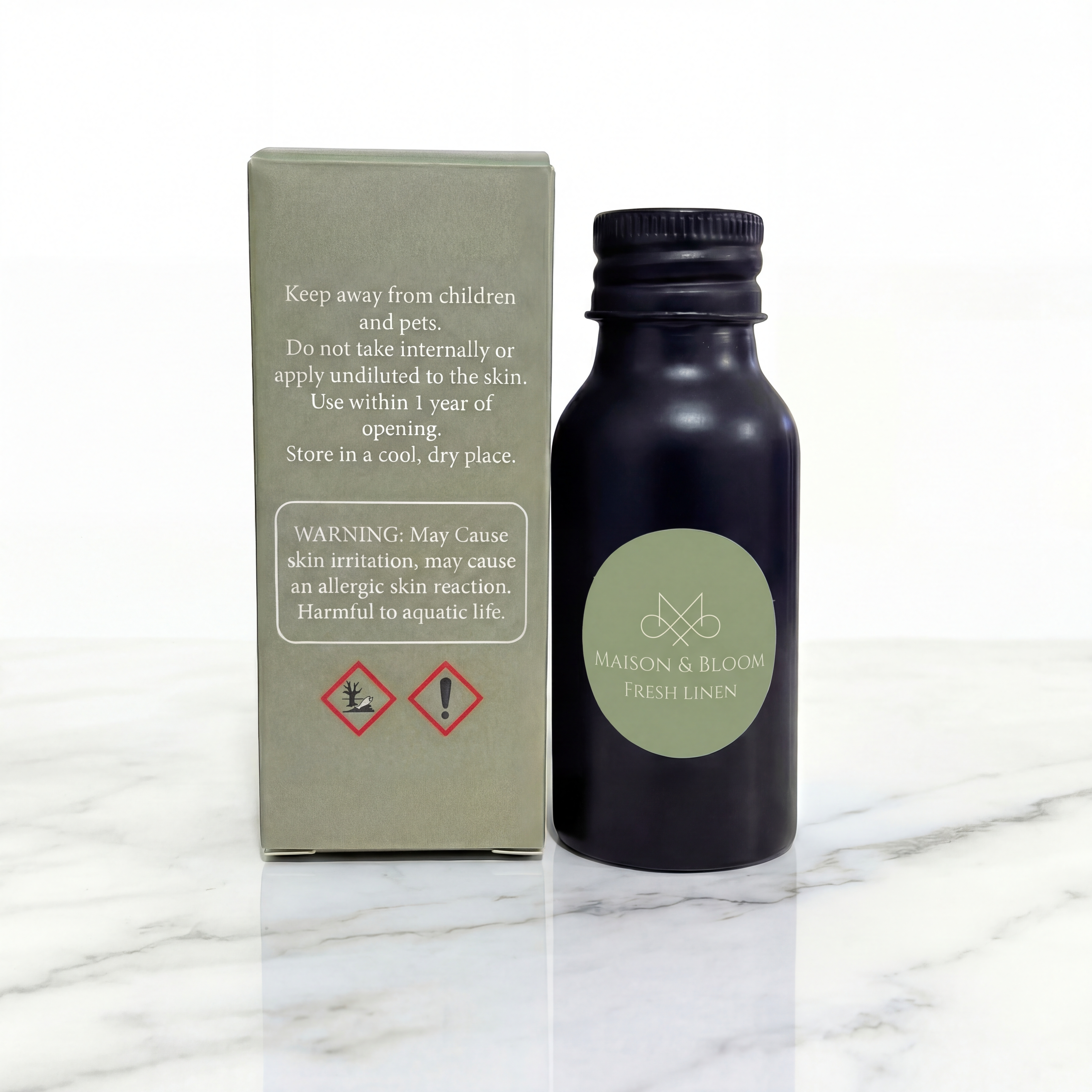 Fresh Linen scented oil bottle and safety label box on marble surface