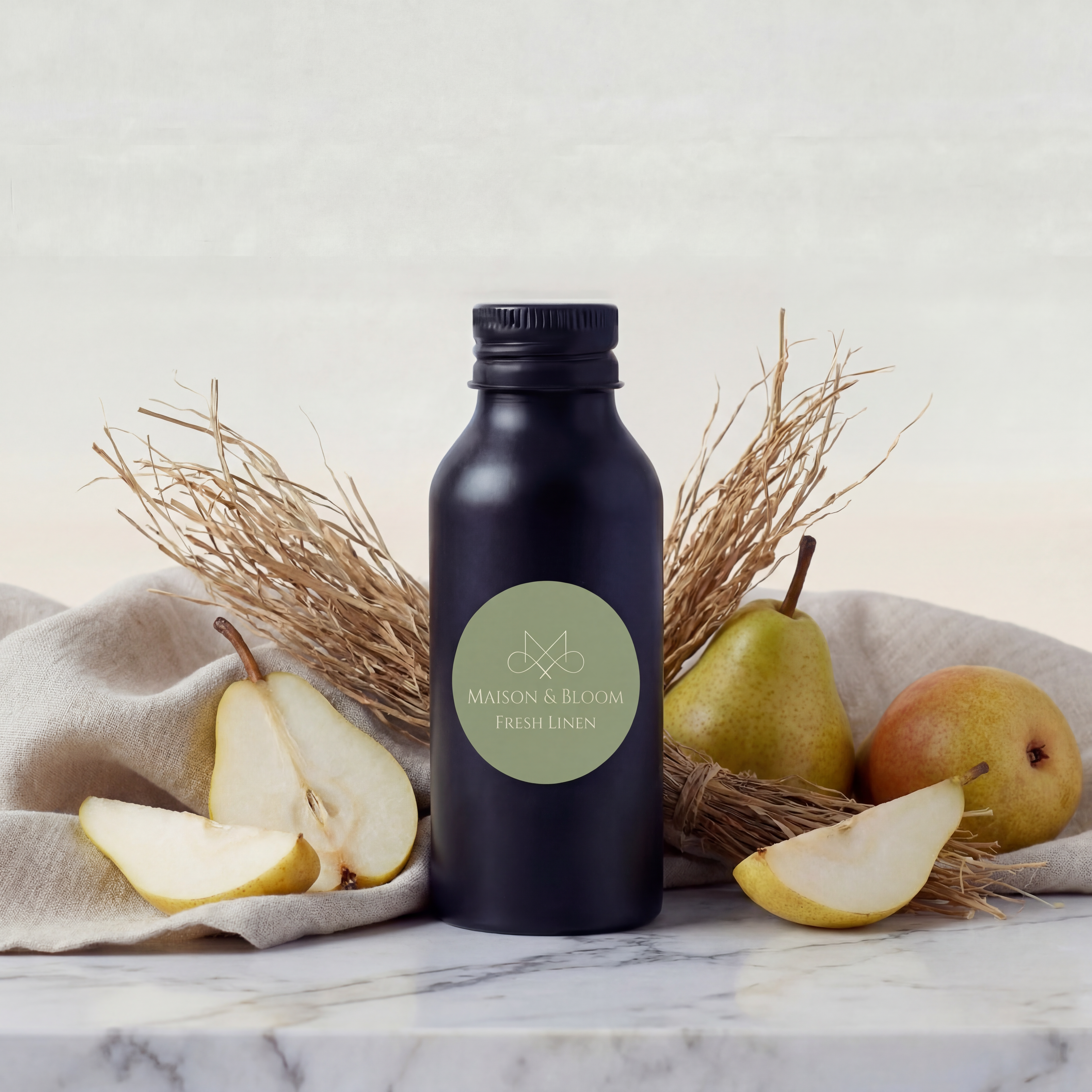 Fresh Linen fragrance bottle with sliced pears, linen cloth, and dried botanicals on marble.