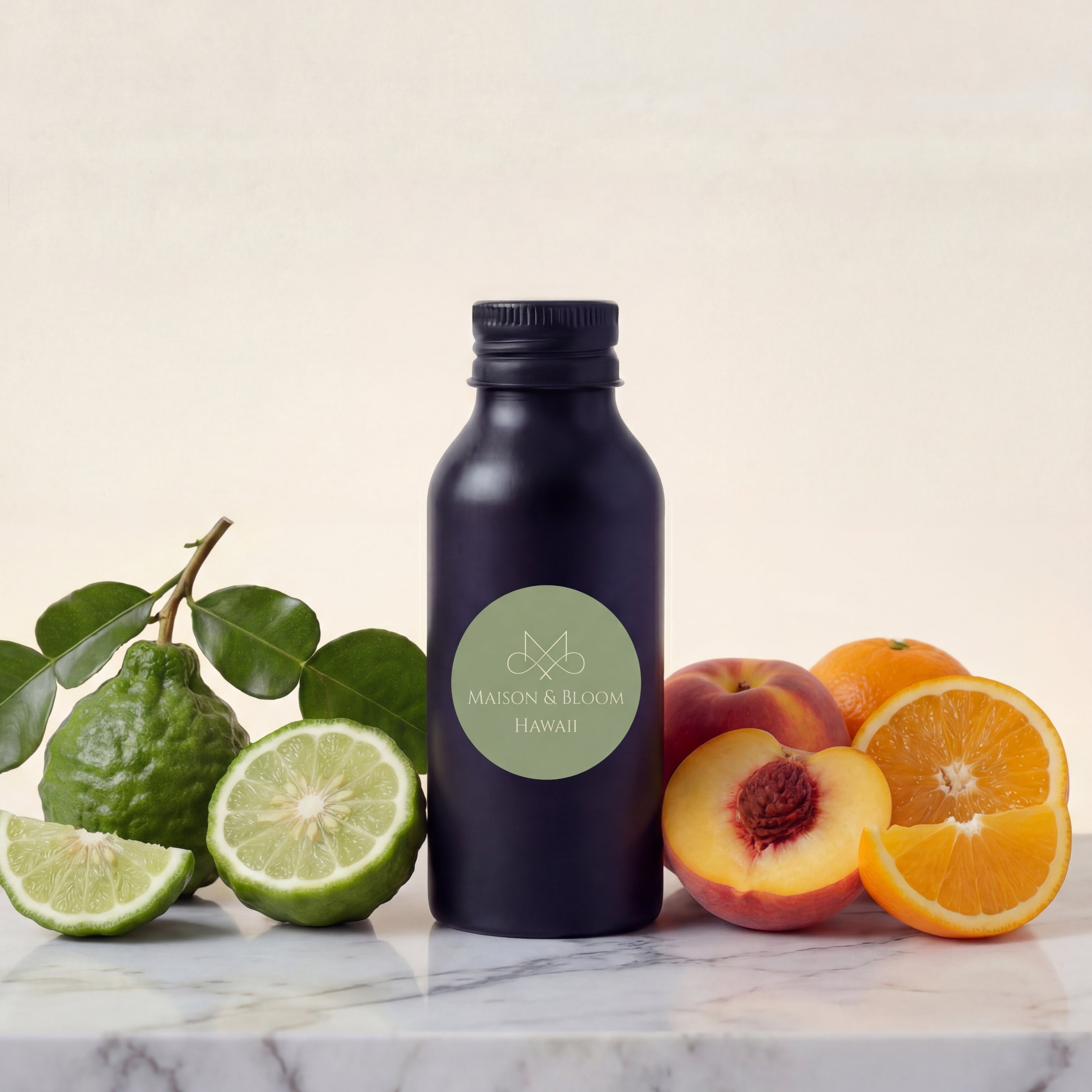 Black bottle labeled 'Maison & Bloom Hawaii' with bergamot, peach, and orange on marble