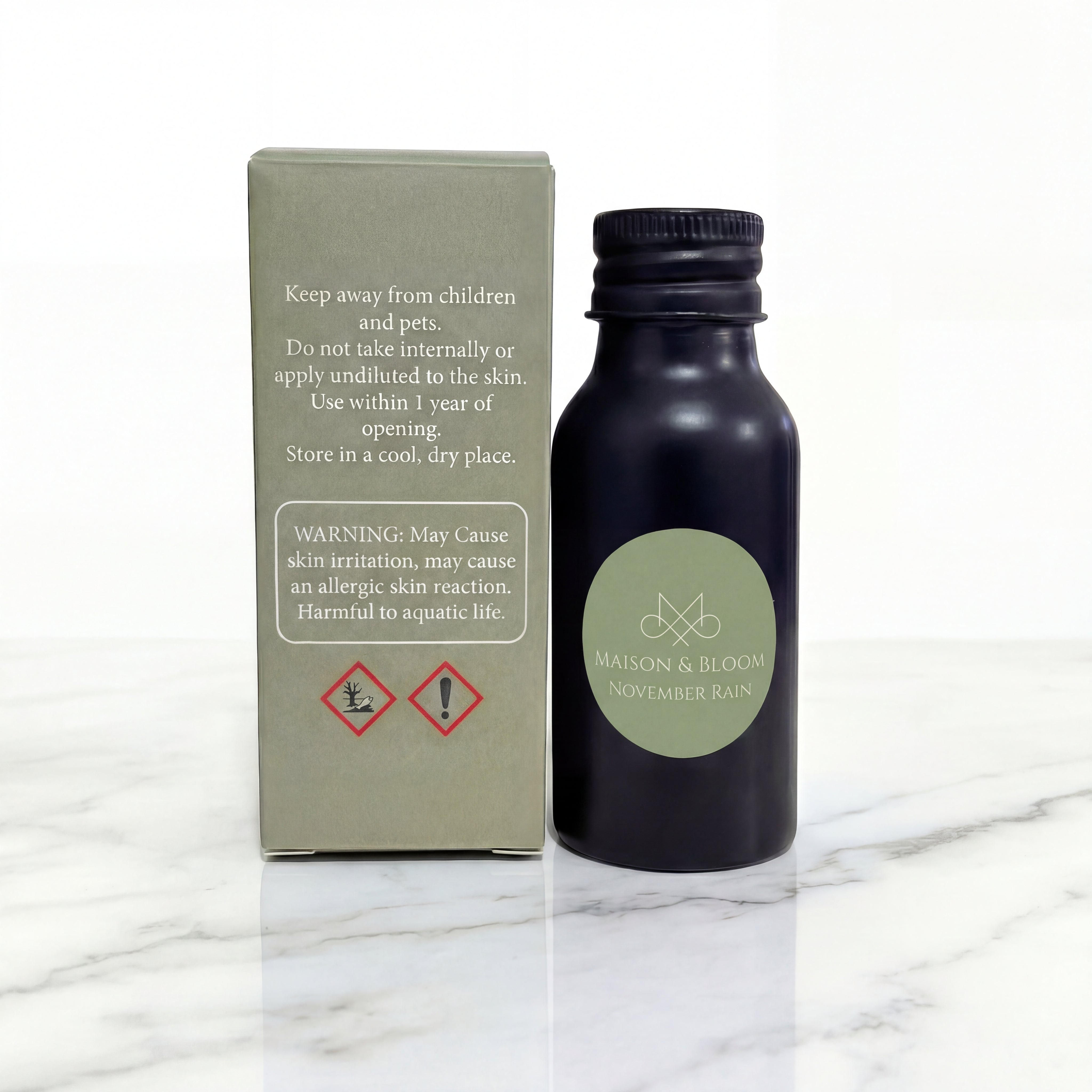 November Rain essential oil bottle with safety box on marble surface