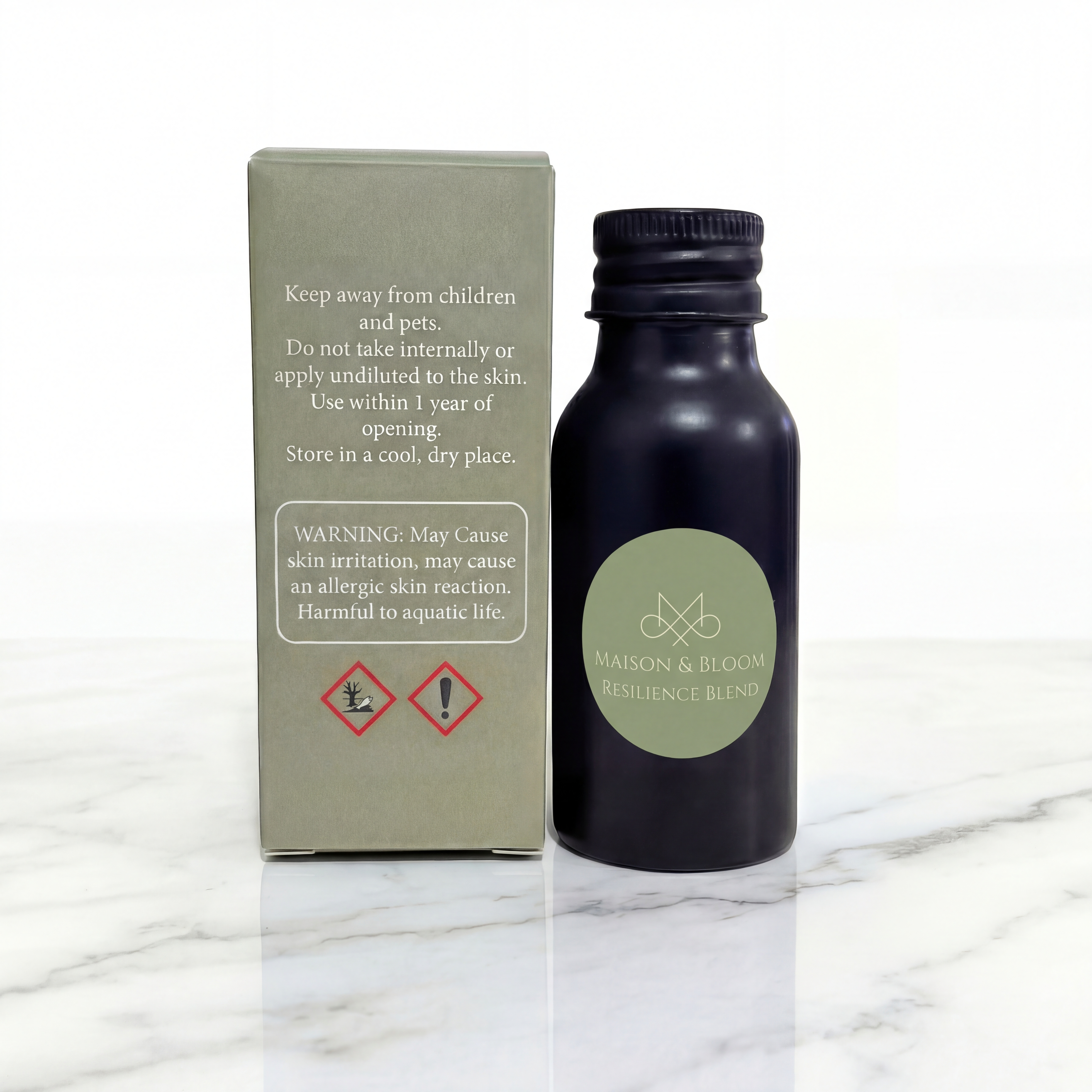 Maison & Bloom Resilience Blend essential oil bottle with safety box on marble surface