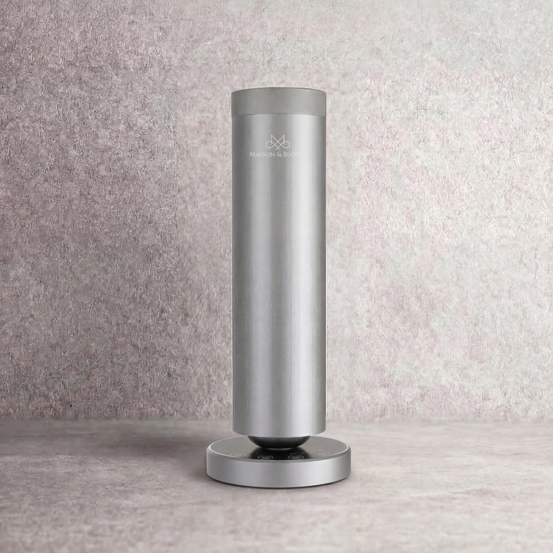 sleek silver essential oil diffuser with minimalist design on a textured surface