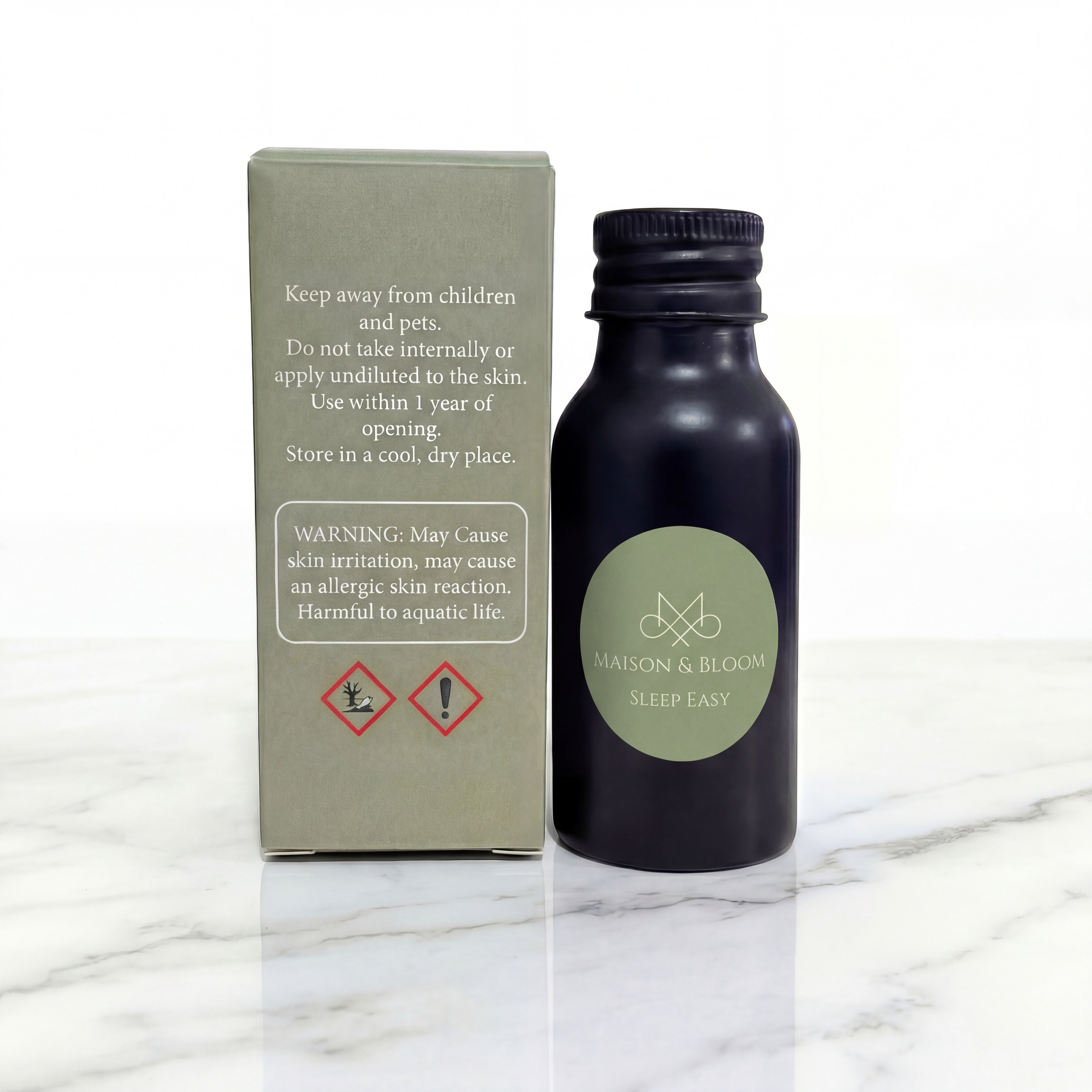 Sleep Easy essential oil bottle and packaging on marble surface with safety warning labels.