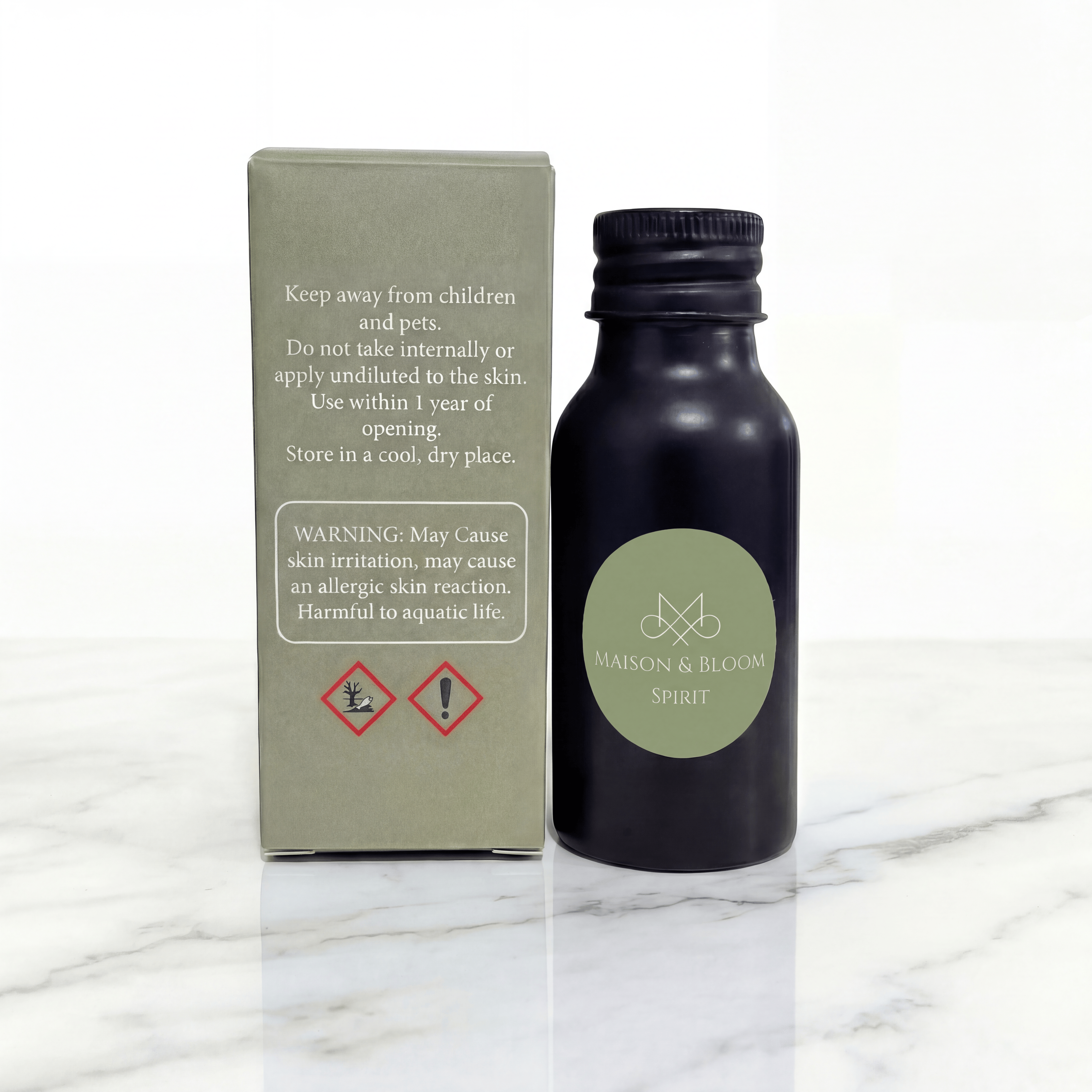 Maison & Bloom Spirit essential oil bottle with safety warning box on marble surface