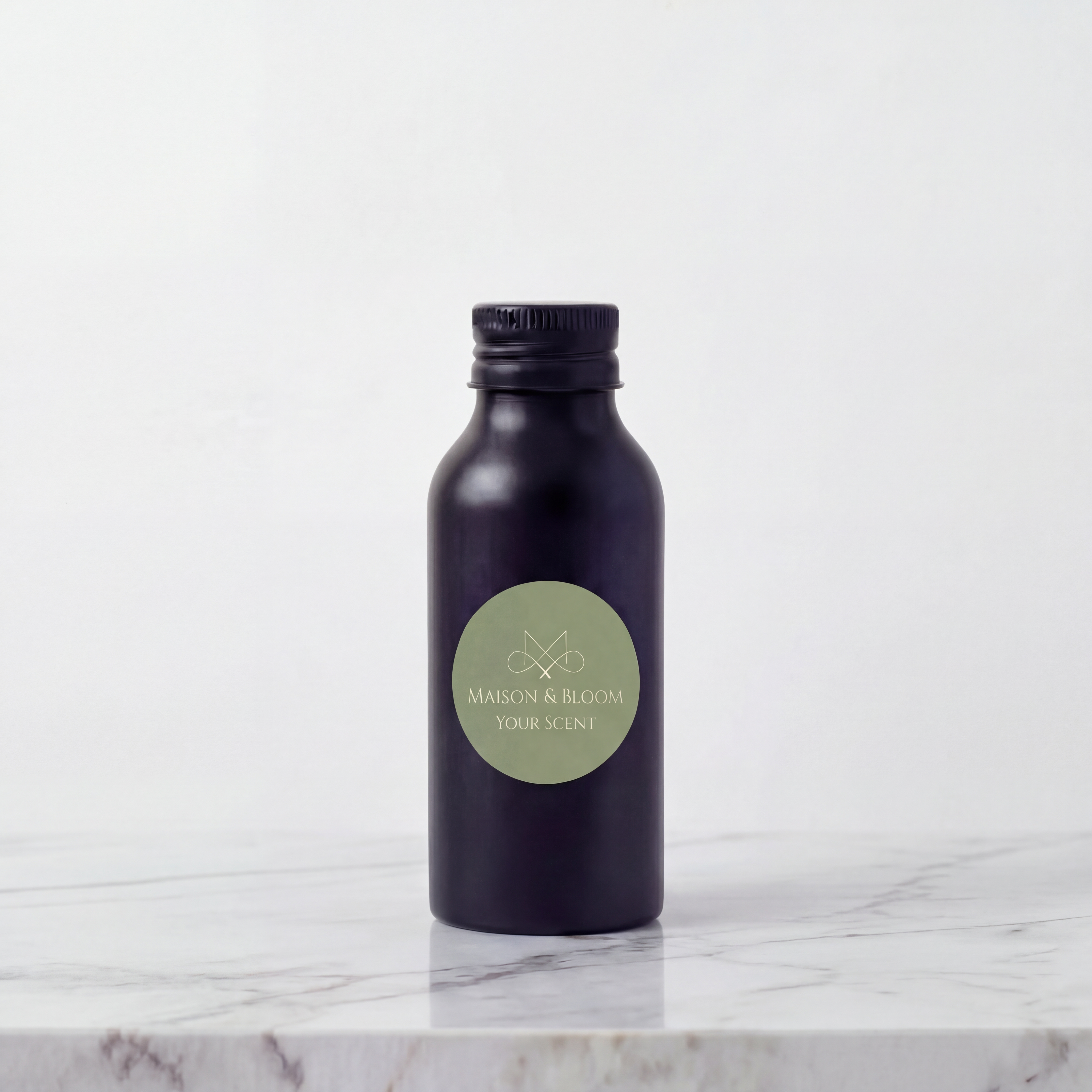 Matte black fragrance bottle with green label on marble surface, minimalist background